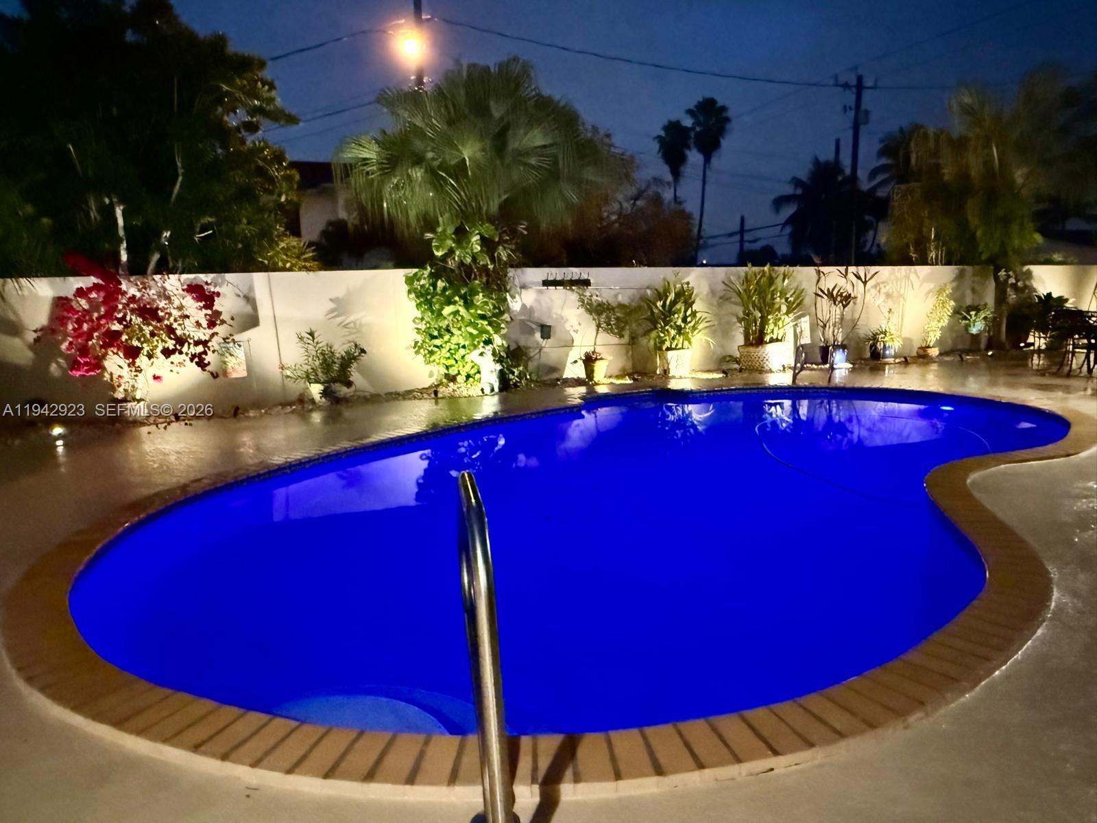2725 Southwest 102nd Avenue Miami, FL 33165 - Photo 33 of 34 a view of a red and white swimming pool with an outdoor seating