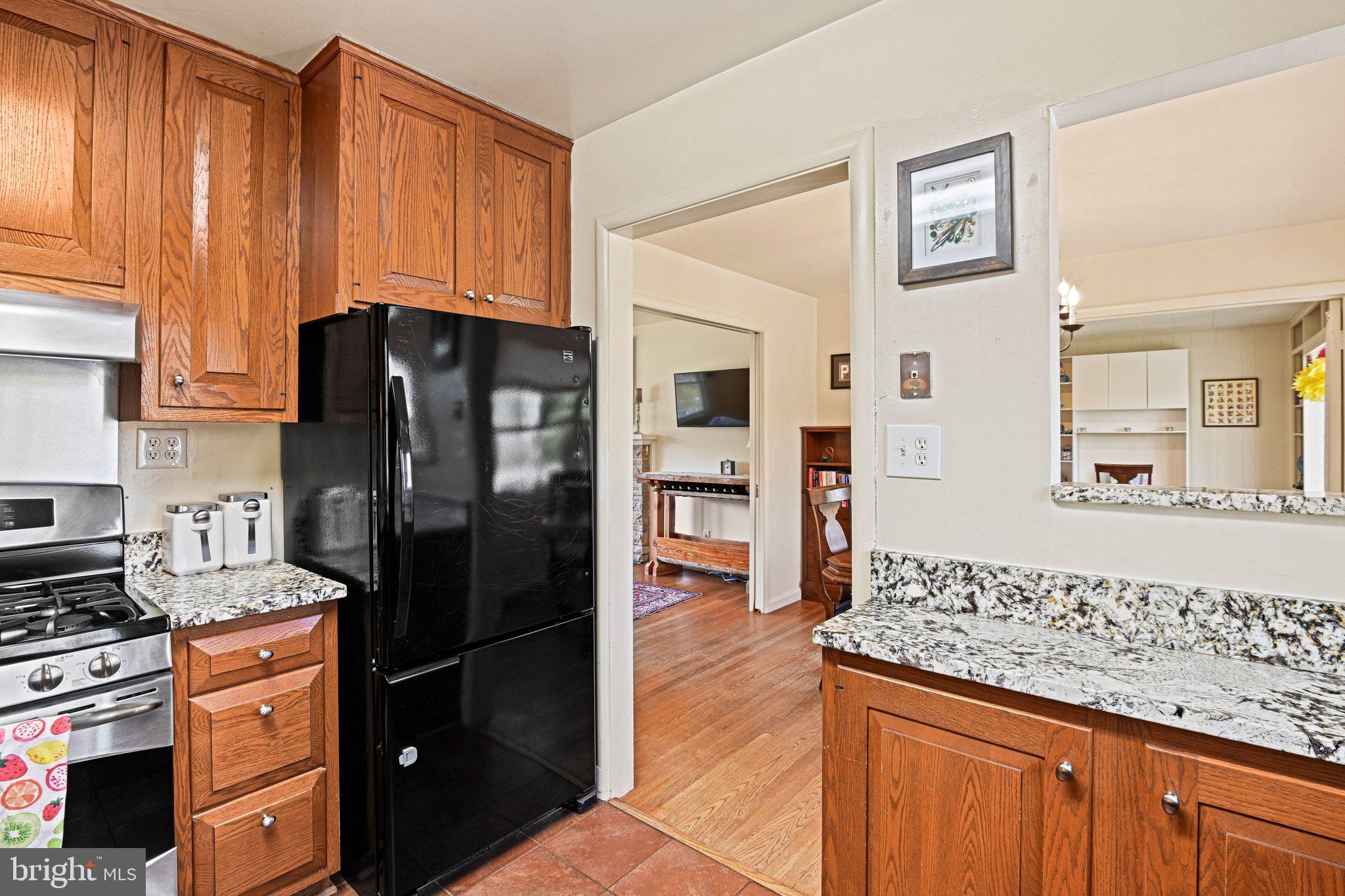 909 Plum Street Southwest Vienna, VA 22180 - Photo 11 of 38 a kitchen with stainless steel appliances granite countertop a refrigerator and a stove top oven