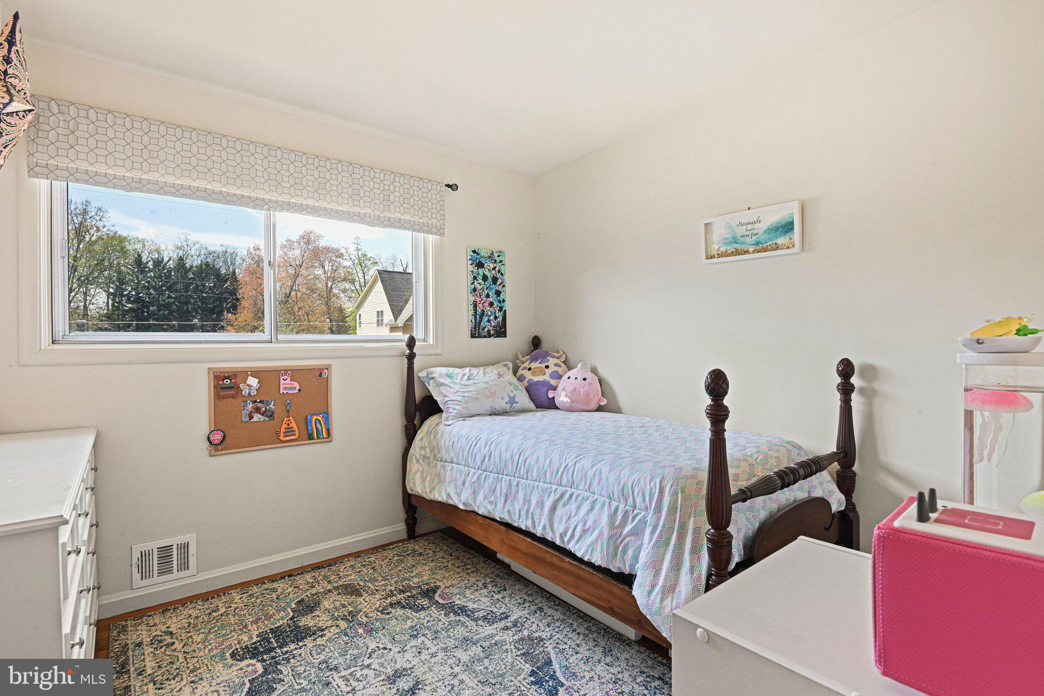 909 Plum Street Southwest Vienna, VA 22180 - Photo 20 of 38 a bed room with a bed and a painting on the wall
