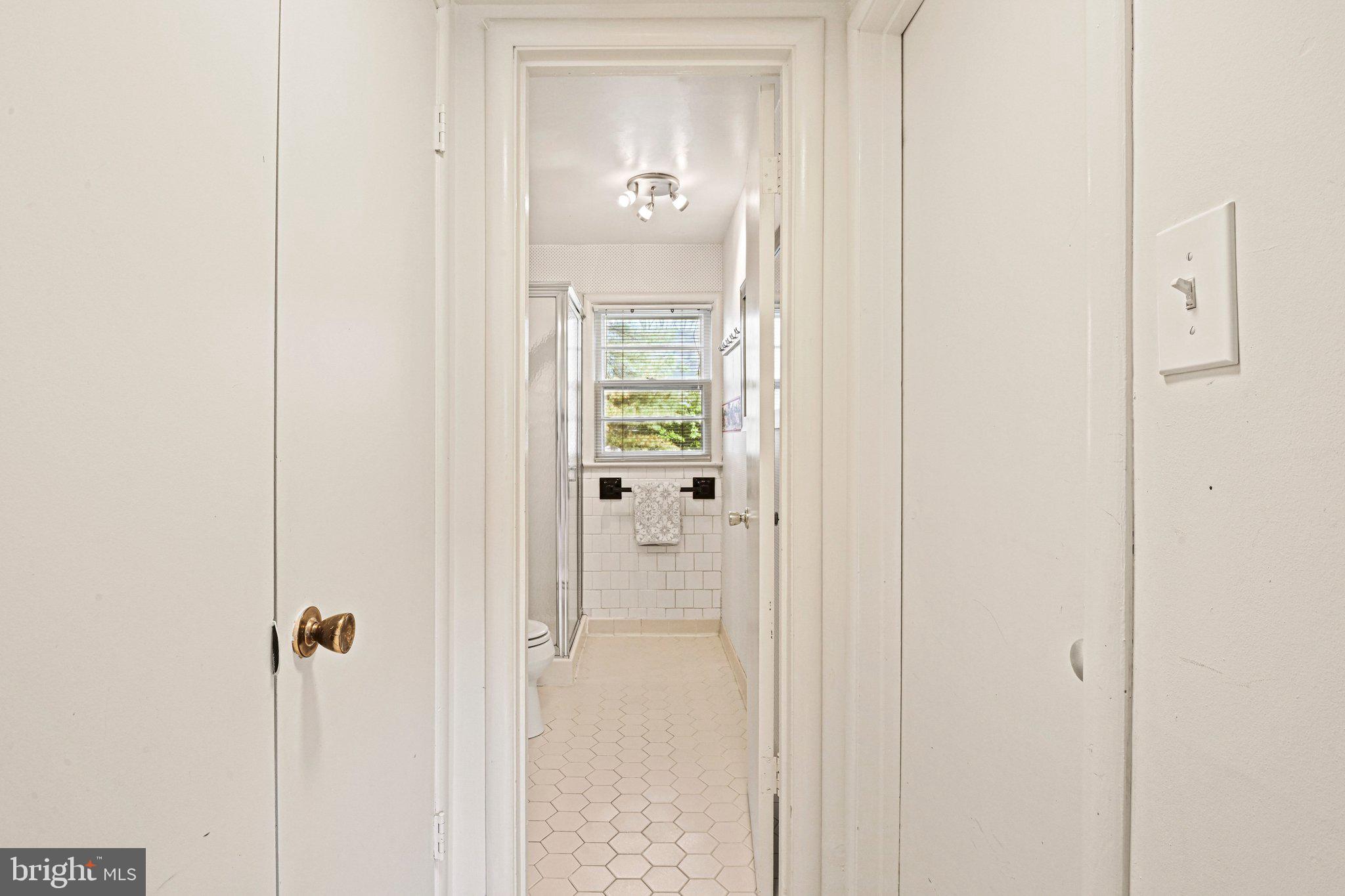 909 Plum Street Southwest Vienna, VA 22180 - Photo 26 of 38 a view of a bathroom from a hallway