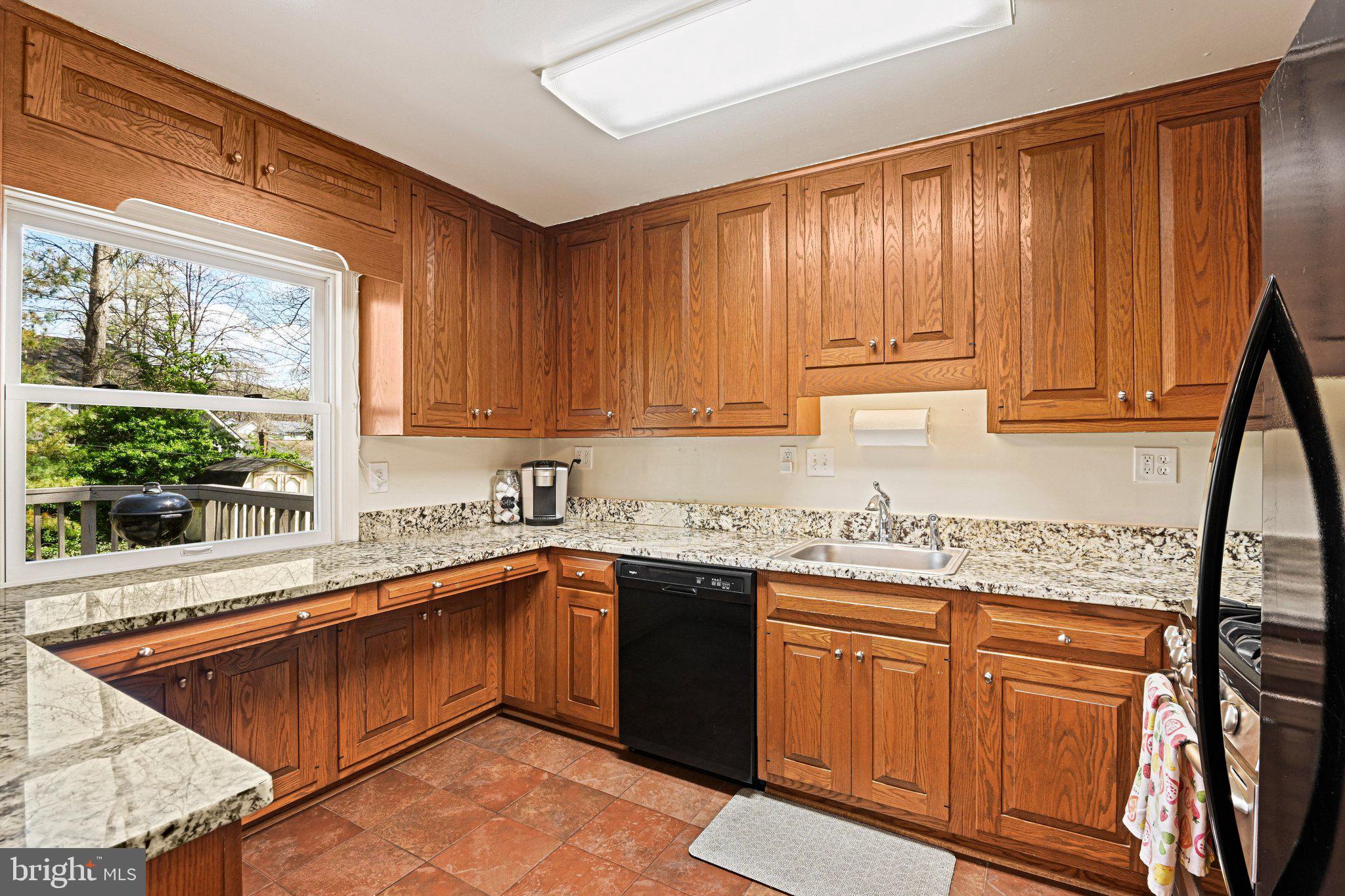 909 Plum Street Southwest Vienna, VA 22180 - Photo 8 of 38 a kitchen with stainless steel appliances granite countertop wooden cabinets a sink and dishwasher