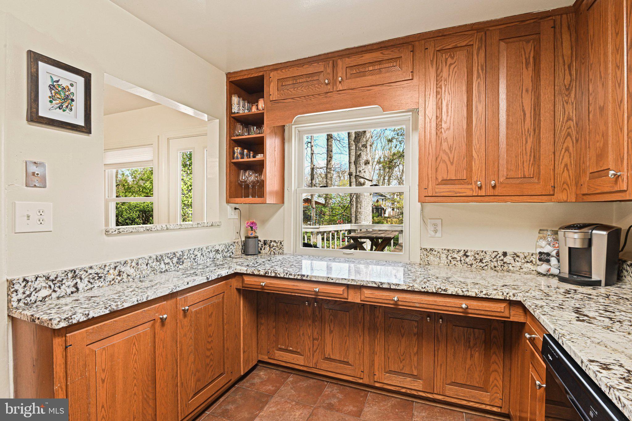 909 Plum Street Southwest Vienna, VA 22180 - Photo 10 of 38 a kitchen with granite countertop a sink and a window
