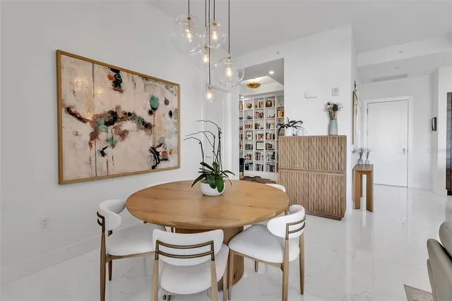 a living room with furniture and a book shelf