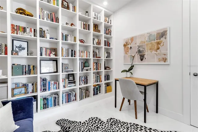 a spacious bedroom with a bed a couch and a large window