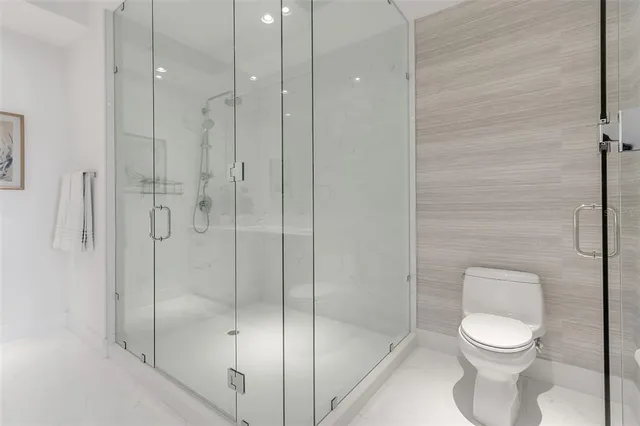 a spacious bedroom with a bed and a large window