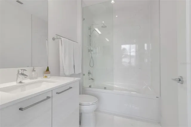 a view of a backyard with plants and furniture