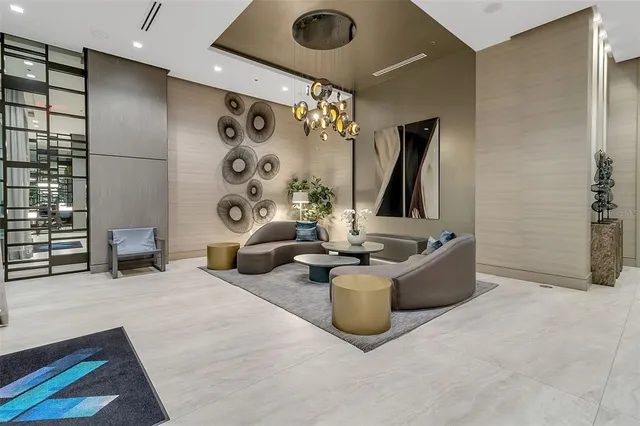 a lobby with furniture and two windows