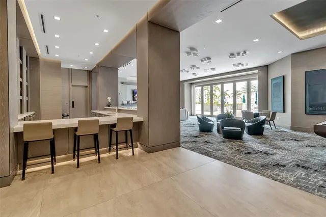 a living room with fireplace furniture and a chandelier