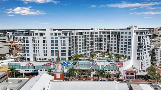 a view of a yard with flower plants and wooden fence