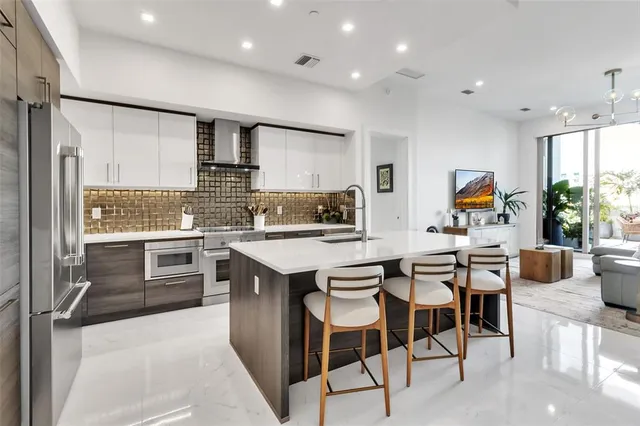 a large kitchen with stainless steel appliances lots of counter space sink and cabinets