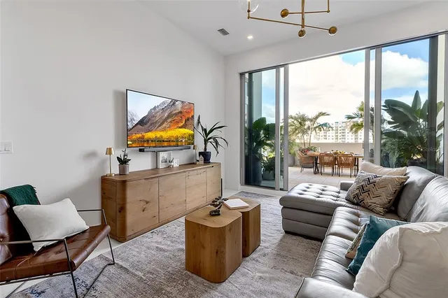 a living room with furniture and kitchen view