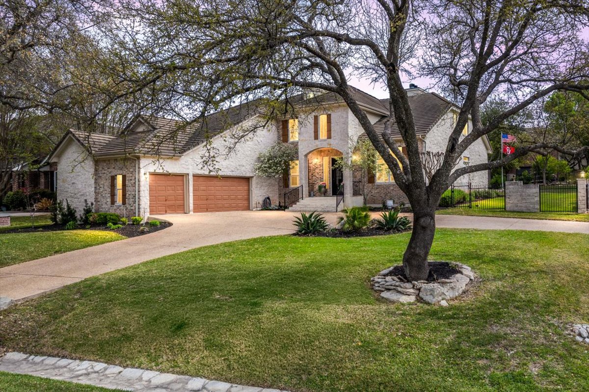 58 Cottondale Road The Hills, TX 78738 - Photo 1 of 40 a front view of a house with garden and trees