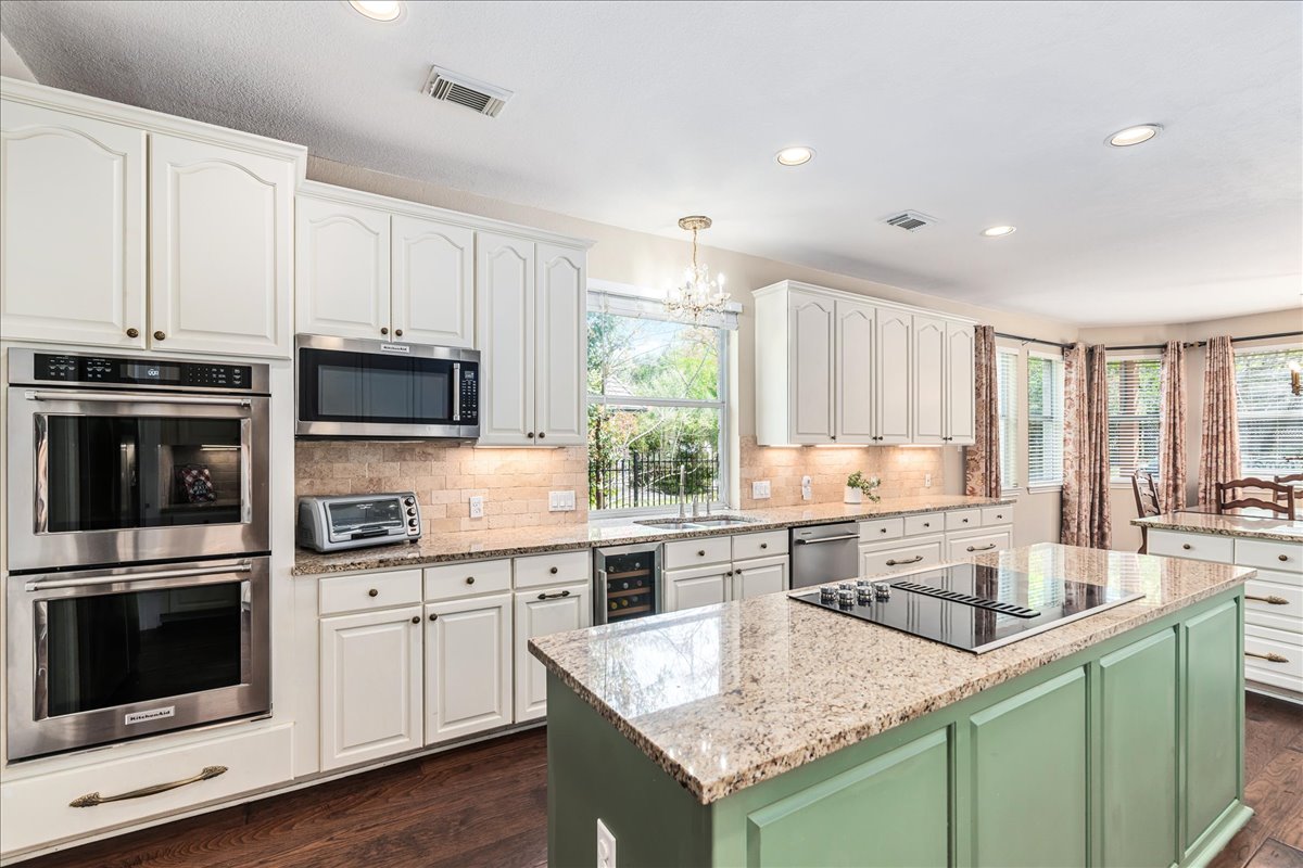 58 Cottondale Road The Hills, TX 78738 - Photo 11 of 40 a kitchen with stainless steel appliances granite countertop a sink stove and microwave