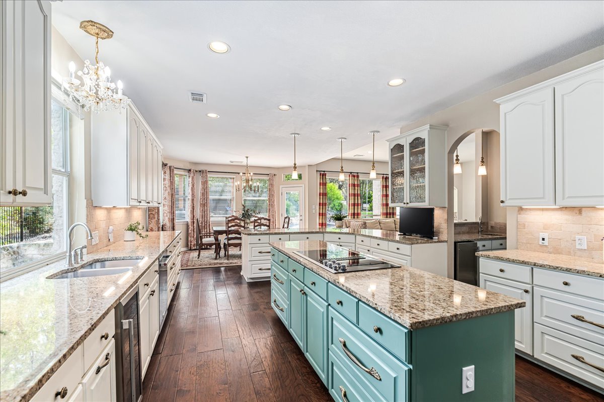 58 Cottondale Road The Hills, TX 78738 - Photo 12 of 40 a kitchen with stainless steel appliances granite countertop a lot of counter space and wooden floors
