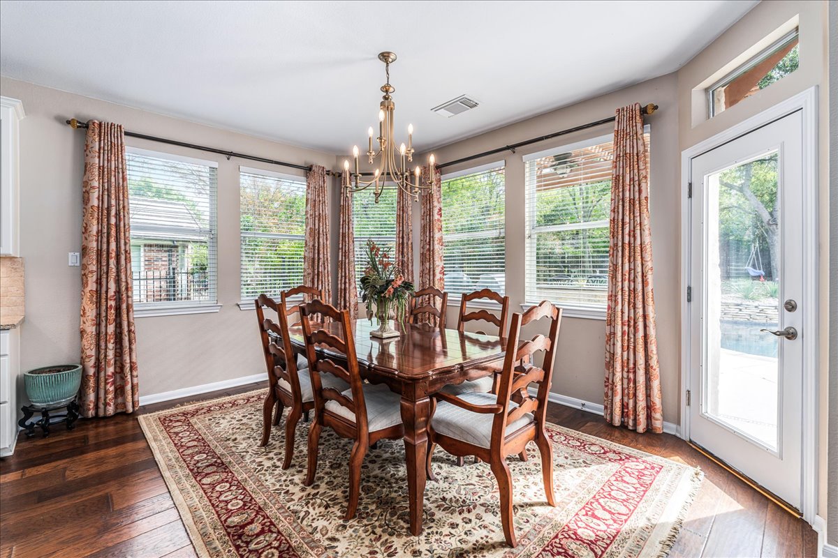 58 Cottondale Road The Hills, TX 78738 - Photo 13 of 40 a view of a dining room with furniture wooden floor and a chandelier