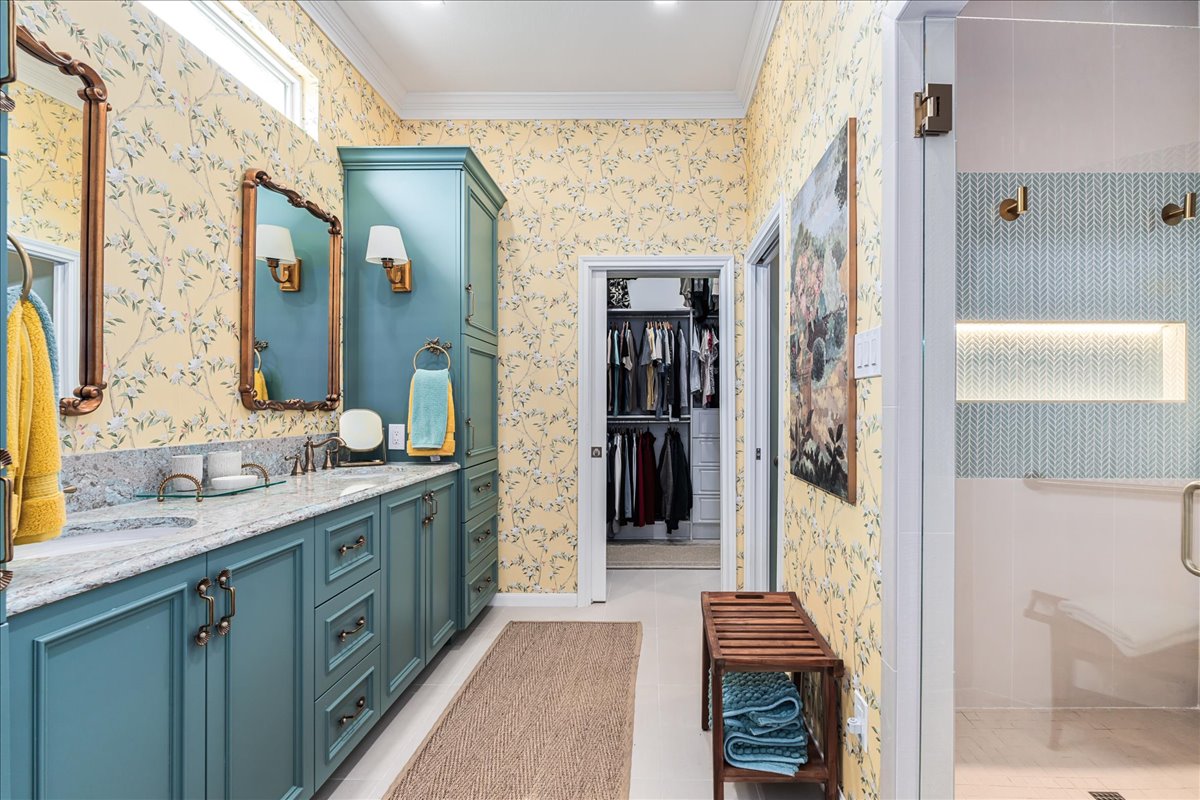 58 Cottondale Road The Hills, TX 78738 - Photo 15 of 40 a bathroom with a granite countertop sink a mirror and shower