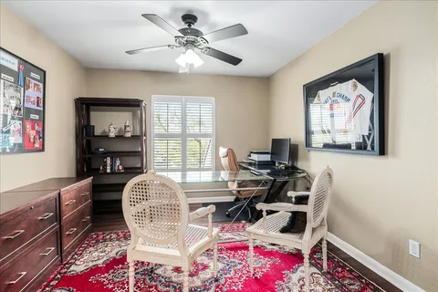 a view of a workspace with furniture and a window