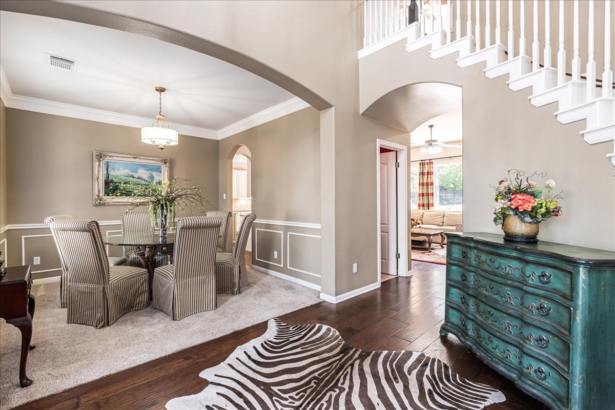 58 Cottondale Road The Hills, TX 78738 - Photo 5 of 40 a view of a dining room with furniture a chandelier and wooden floor