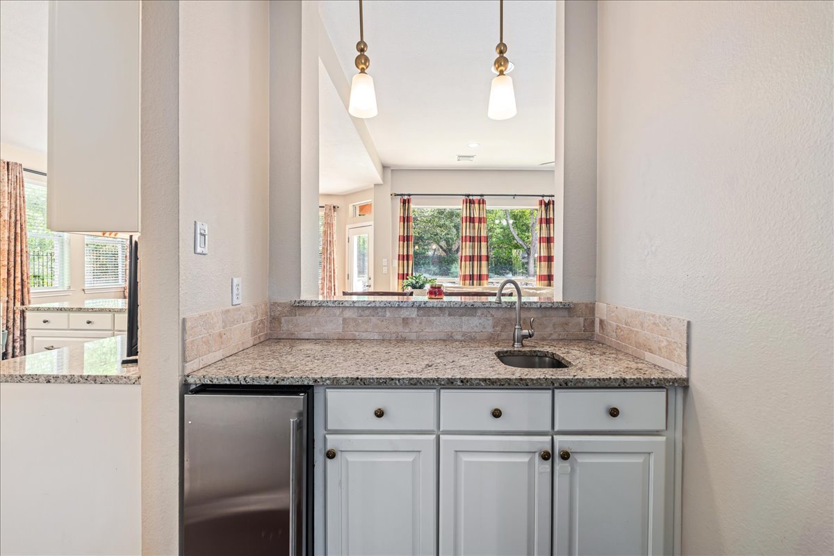 58 Cottondale Road The Hills, TX 78738 - Photo 9 of 40 a kitchen with granite countertop a sink and a window