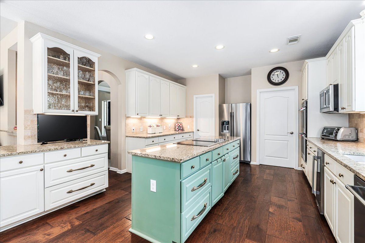 58 Cottondale Road The Hills, TX 78738 - Photo 10 of 40 a kitchen with stainless steel appliances granite countertop a stove and a refrigerator