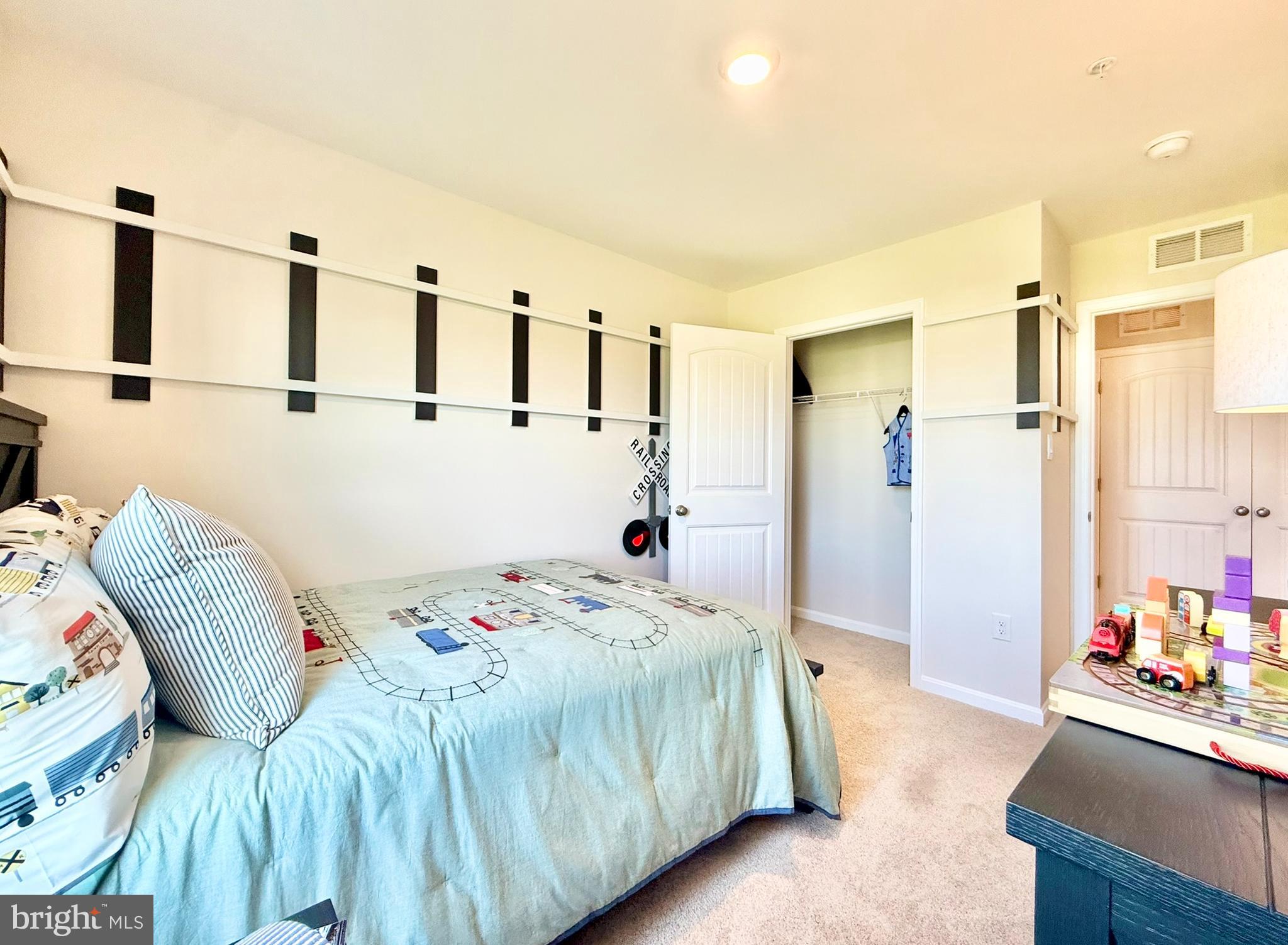 21469 Farmington Road Frankford, DE 19945 - Photo 28 of 30 a bedroom with a bed table and a large mirror