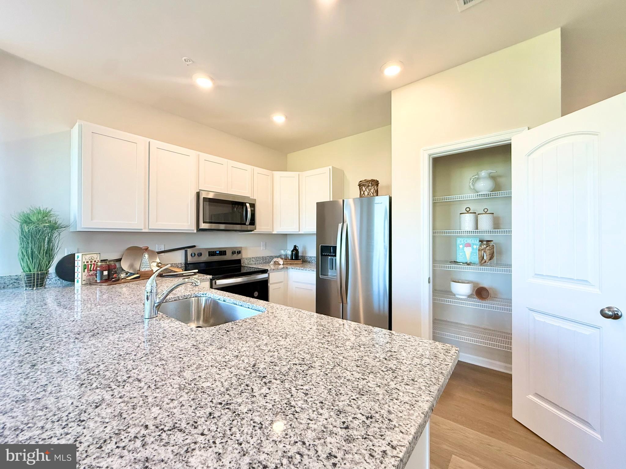 21469 Farmington Road Frankford, DE 19945 - Photo 10 of 30 a kitchen with stainless steel appliances granite countertop a refrigerator stove top oven a sink and dishwasher