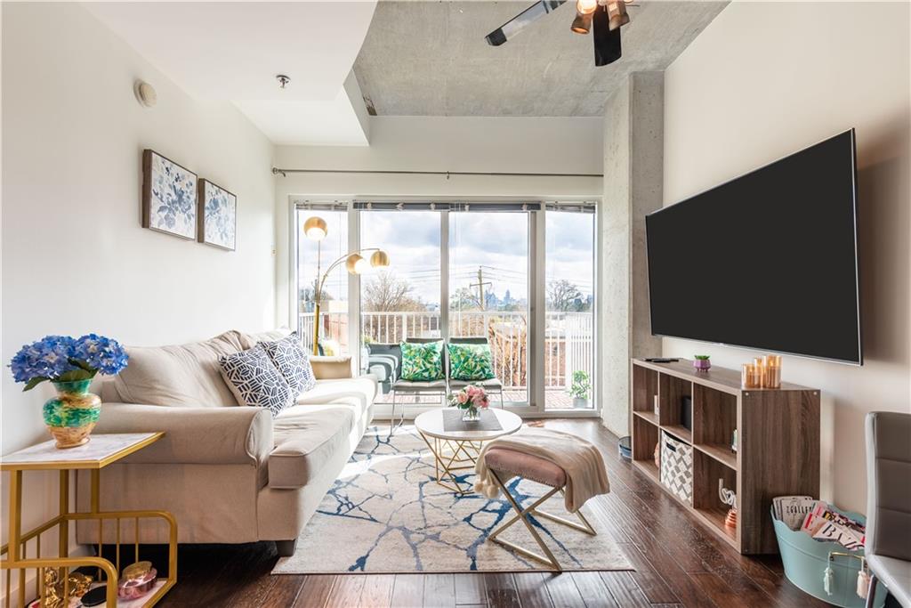 a living room with furniture and a flat screen tv