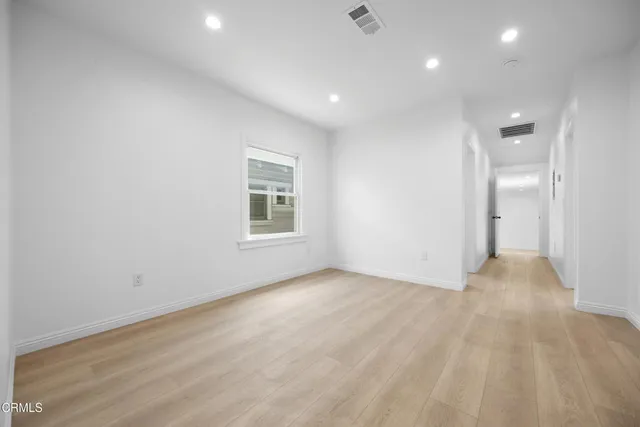 an empty room with windows and closet