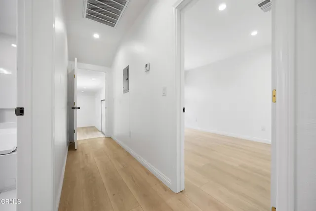 a view of hallway with wooden floor
