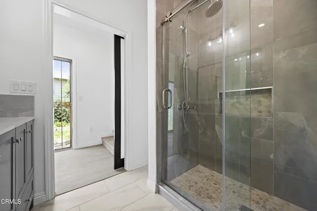 a bathroom with a shower and a sink