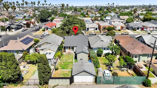 an aerial view of a houses with yard