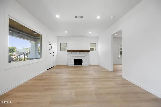 a view of an empty room with a fireplace