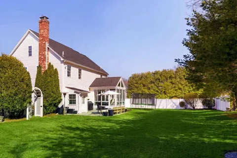 a view of house with a big yard