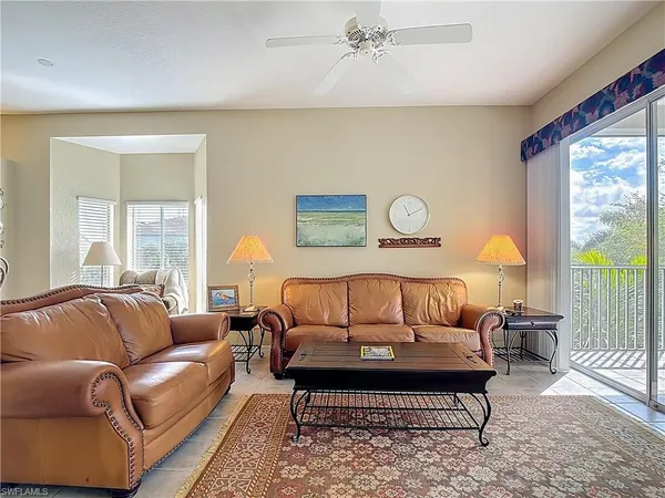 a bedroom with a bed couch and window