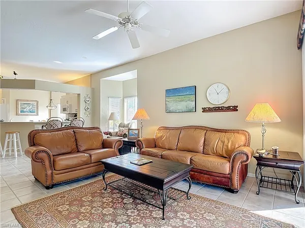 a living room with furniture a rug and a lamp