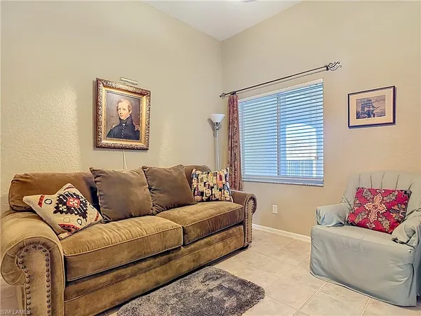 a living room with a couch next to a window and a couch