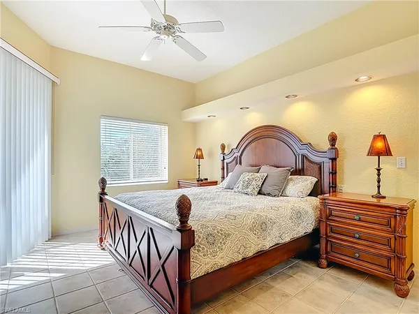 a bedroom with a bed and a dresser with the outer view