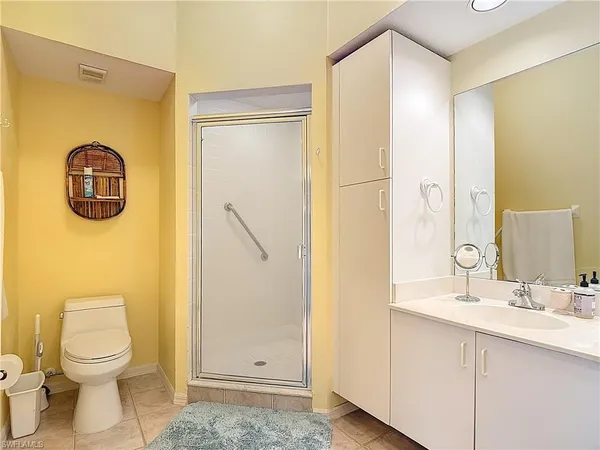 a bathroom with a toilet sink and shower