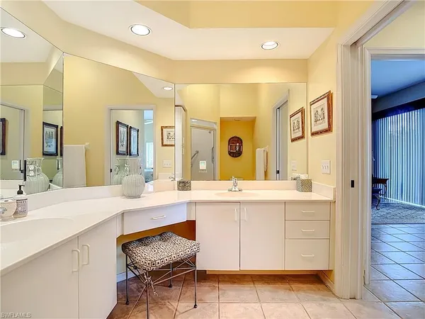 a spacious bathroom with a double vanity sink and a mirror