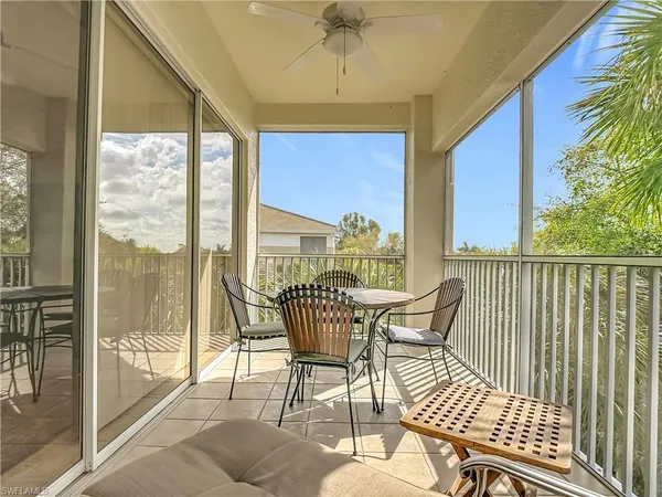 a dining room with furniture a chandelier and glass door