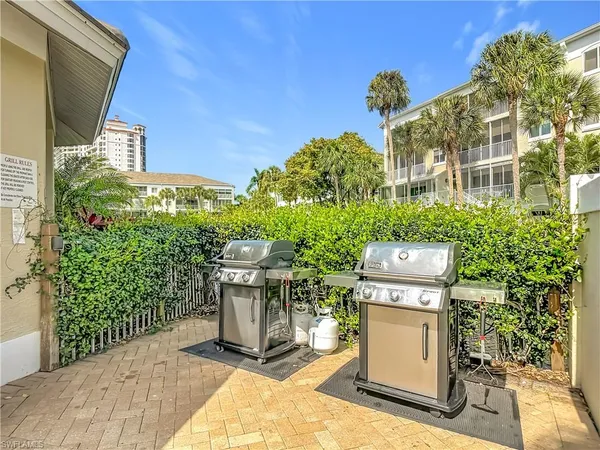 a view of a patio with table and chairs and potted plants