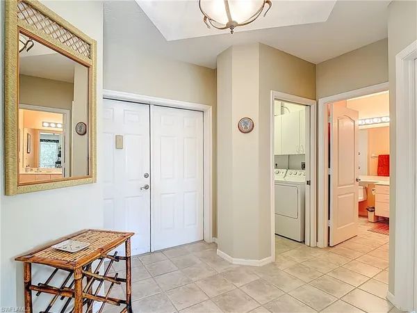 a view of a hallway and an dining rom with furniture