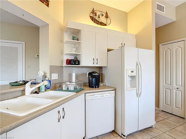 a kitchen with stainless steel appliances a refrigerator sink and cabinets
