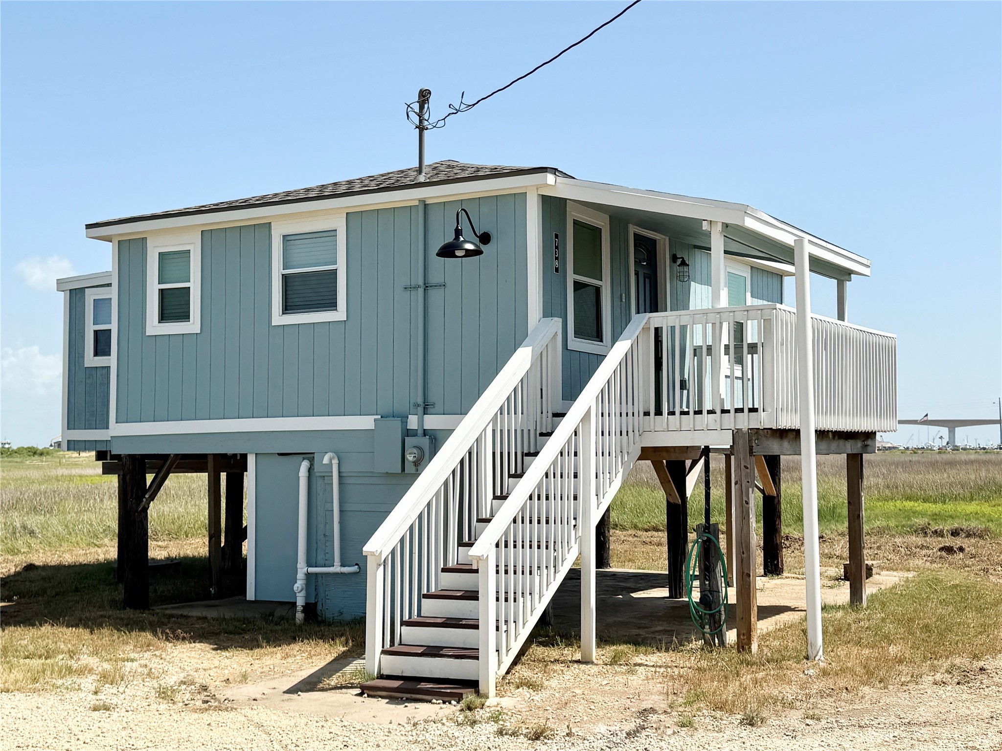 738 Caisson Street Surfside Beach, TX 77541 - Photo 1 of 19 a front view of a house with entryway
