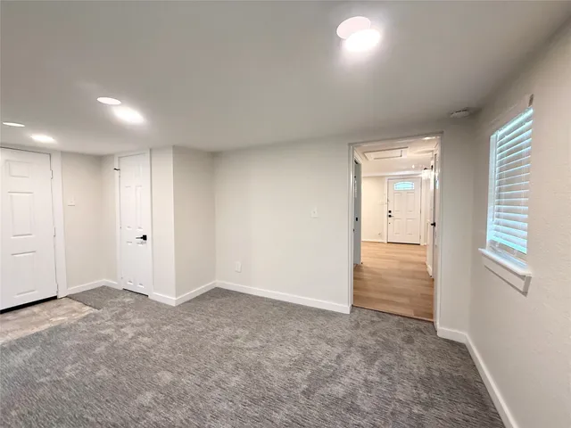 an empty room with windows and closet
