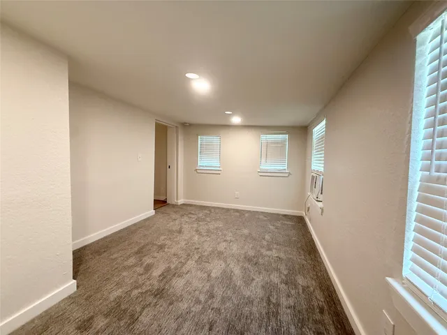 a view of an empty room and a window