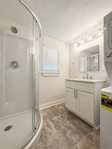 a spacious bathroom with a granite countertop sink a toilet and shower
