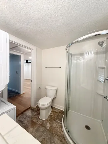 a bathroom with a shower and a toilet