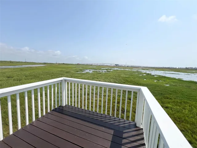 a balcony with wooden floor and fence