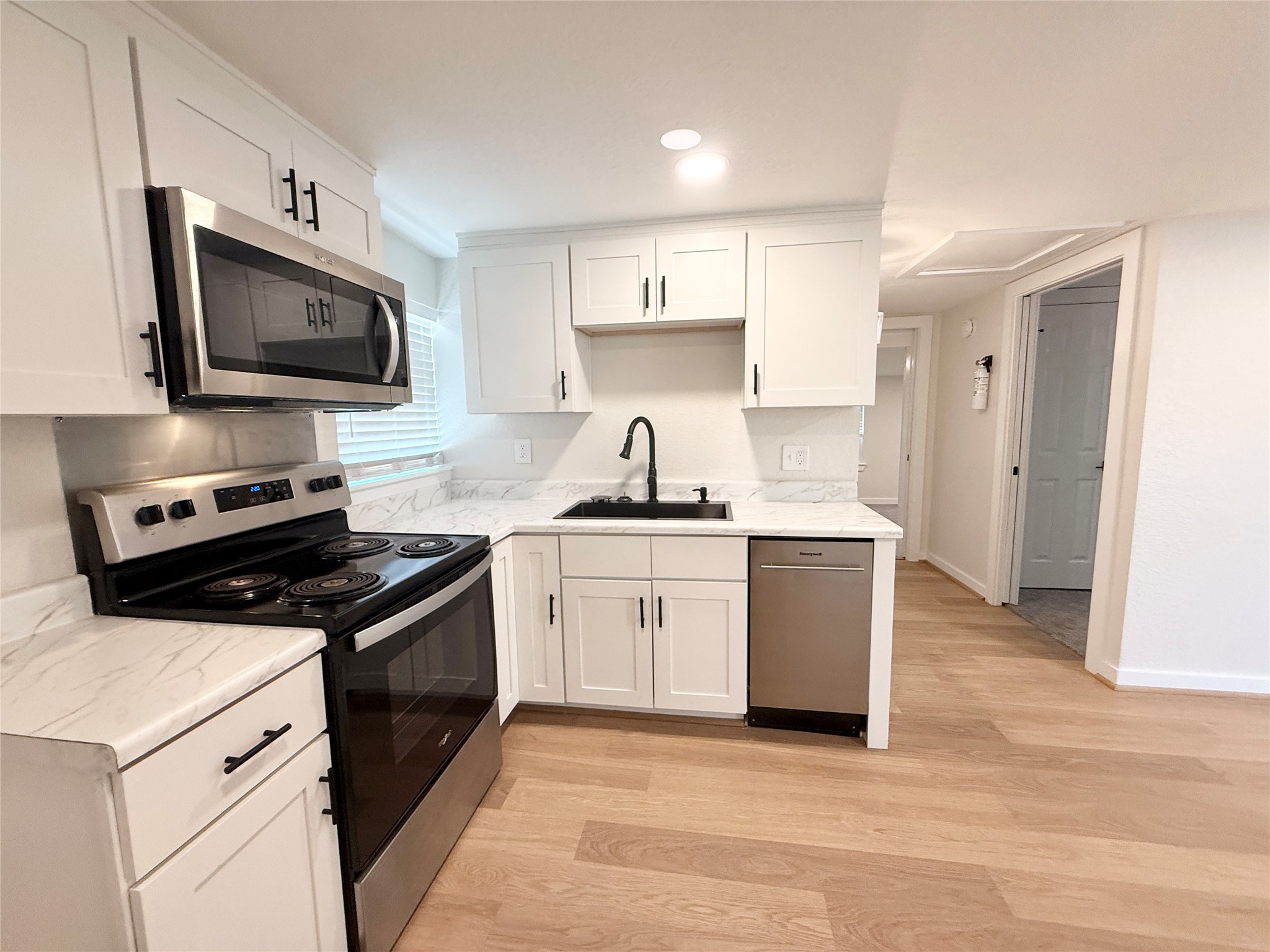 738 Caisson Street Surfside Beach, TX 77541 - Photo 9 of 19 a kitchen with a sink stove and microwave